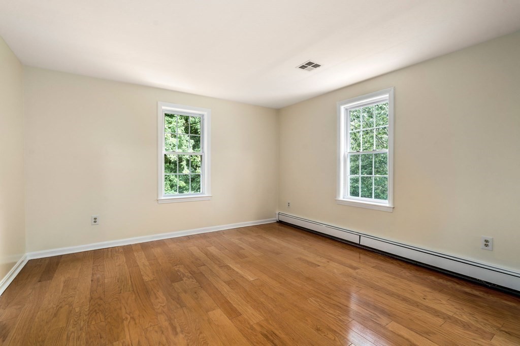 98 Allen Street Walpole, MA 02081 - Photo 26 of 37 an empty room with wooden floor and windows