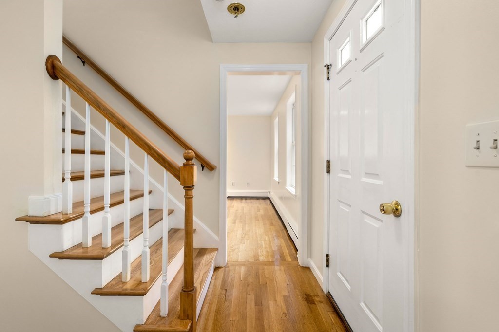 98 Allen Street Walpole, MA 02081 - Photo 3 of 37 a view of a hallway with wooden floor and staircase