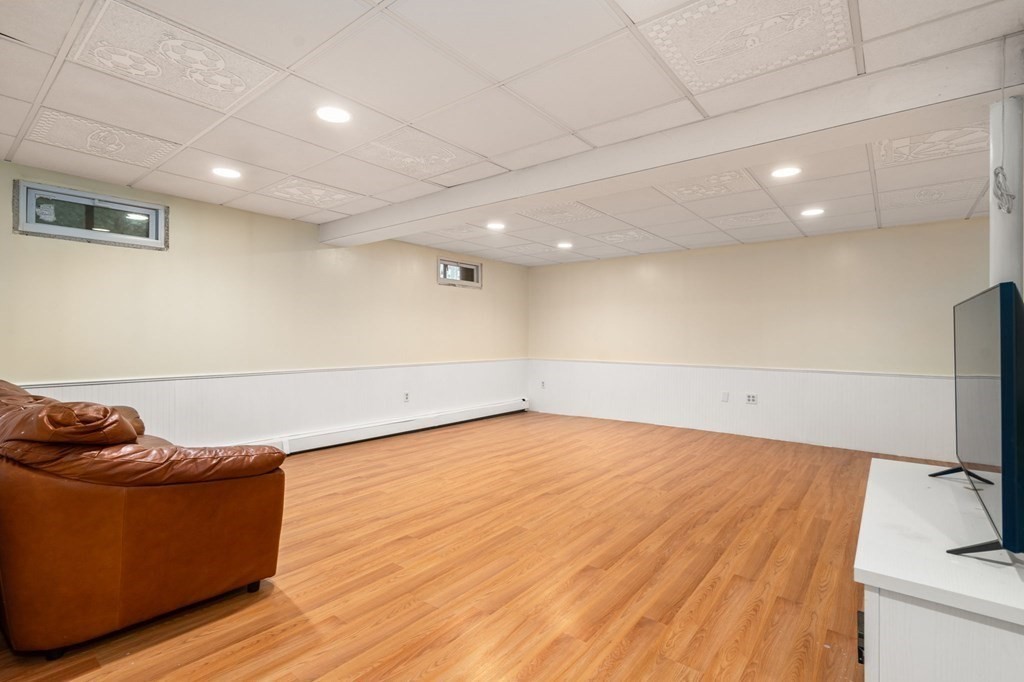 98 Allen Street Walpole, MA 02081 - Photo 32 of 37 a room with wooden floor and furniture