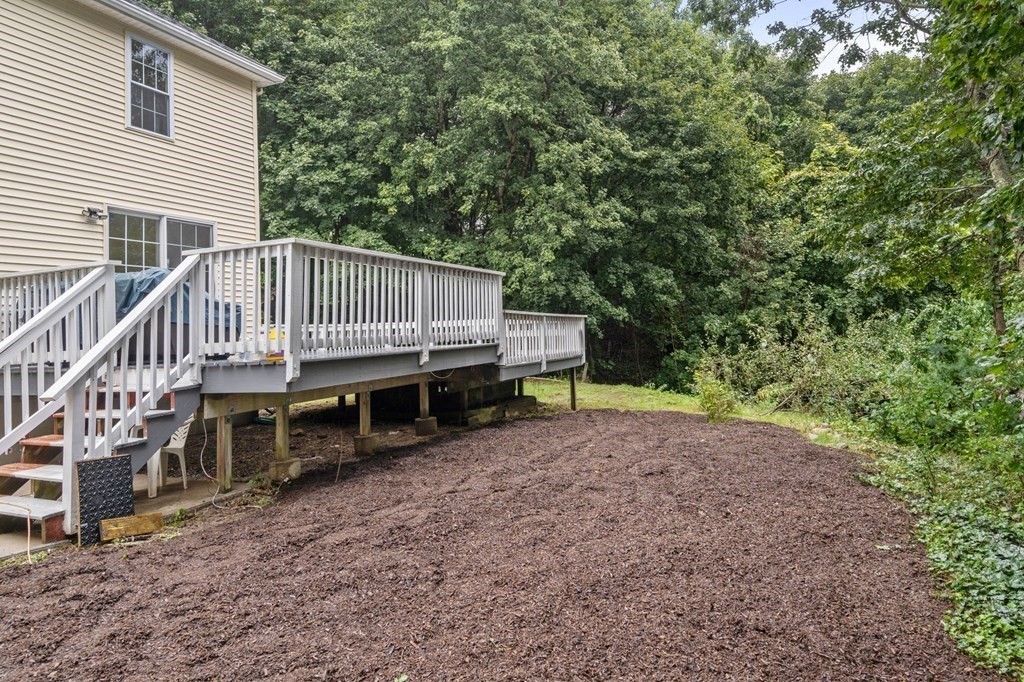 98 Allen Street Walpole, MA 02081 - Photo 35 of 37 a view of a house with a deck and a yard