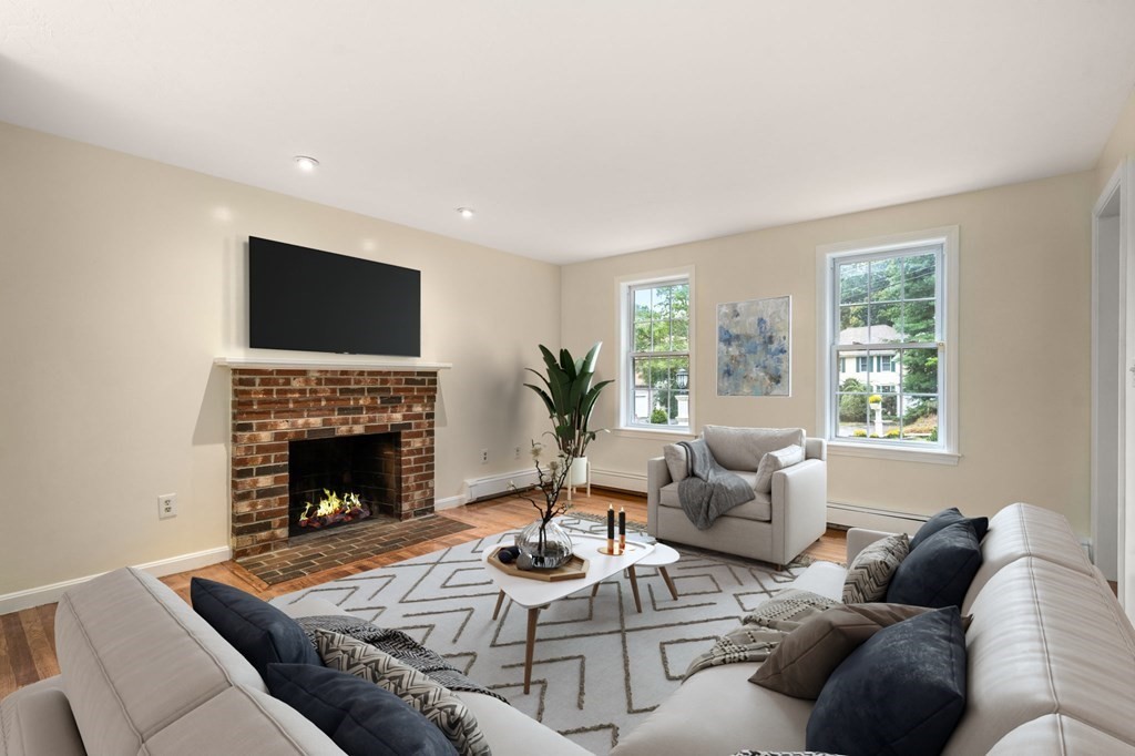 98 Allen Street Walpole, MA 02081 - Photo 4 of 37 a living room with furniture a fireplace and a flat screen tv