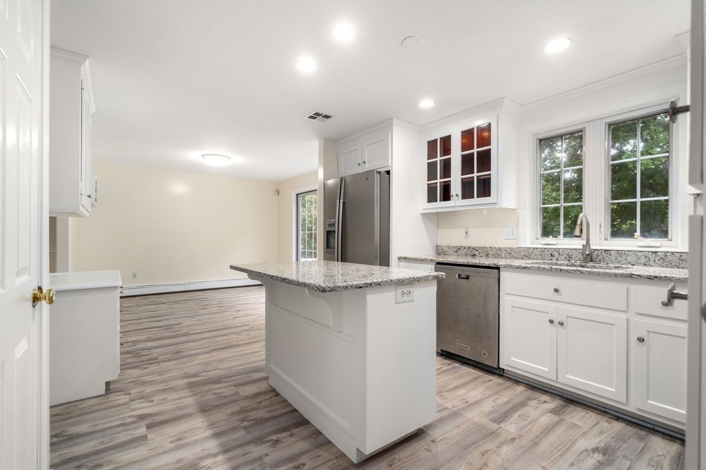 98 Allen Street Walpole, MA 02081 - Photo 7 of 37 a kitchen with granite countertop a sink and cabinets