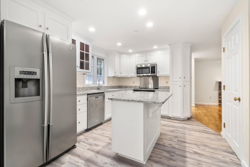 98 Allen Street Walpole, MA 02081 - Photo 8 of 37 a kitchen with stainless steel appliances granite countertop a refrigerator and a stove top oven