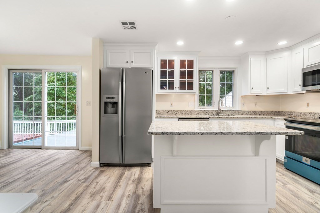 98 Allen Street Walpole, MA 02081 - Photo 9 of 37 a kitchen with stainless steel appliances granite countertop a refrigerator and a sink