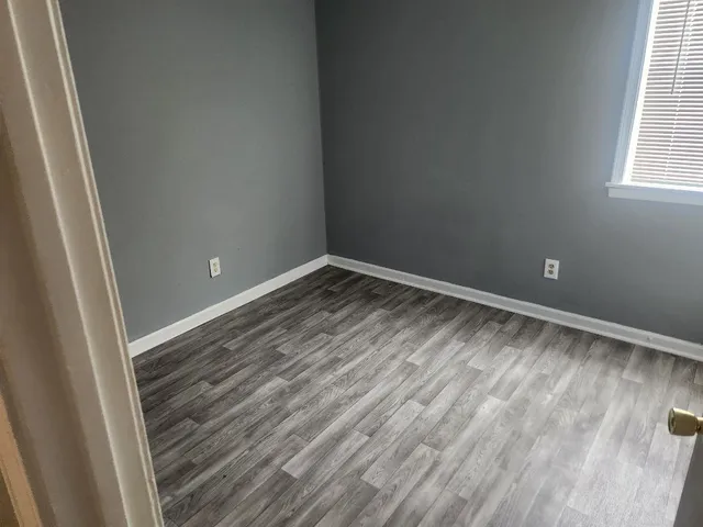 a view of room with window and hardwood floor