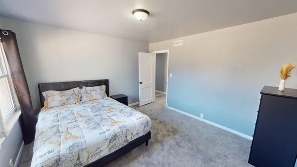 a bedroom with a bed and a night stand