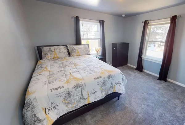 a bedroom with a bed and window
