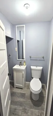 a white toilet sitting next to a bathroom sink
