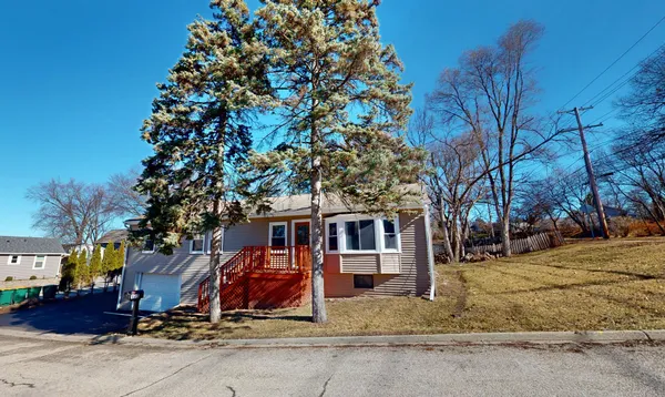 a view of a house with snow next to a road