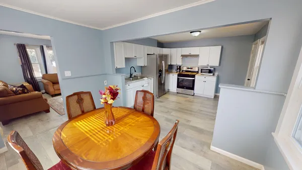 a dining room with furniture and wooden floor