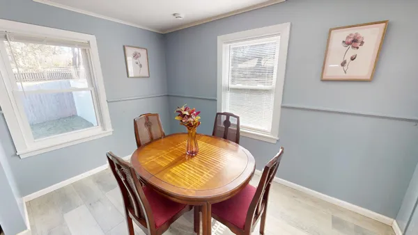 a view of a dining room with furniture and a window