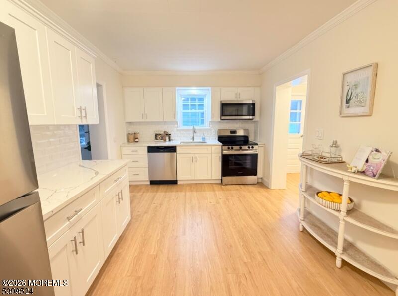 484 Bara Street Brick, NJ 08723 - Photo 7 of 15 a large kitchen with a stove a sink and a refrigerator
