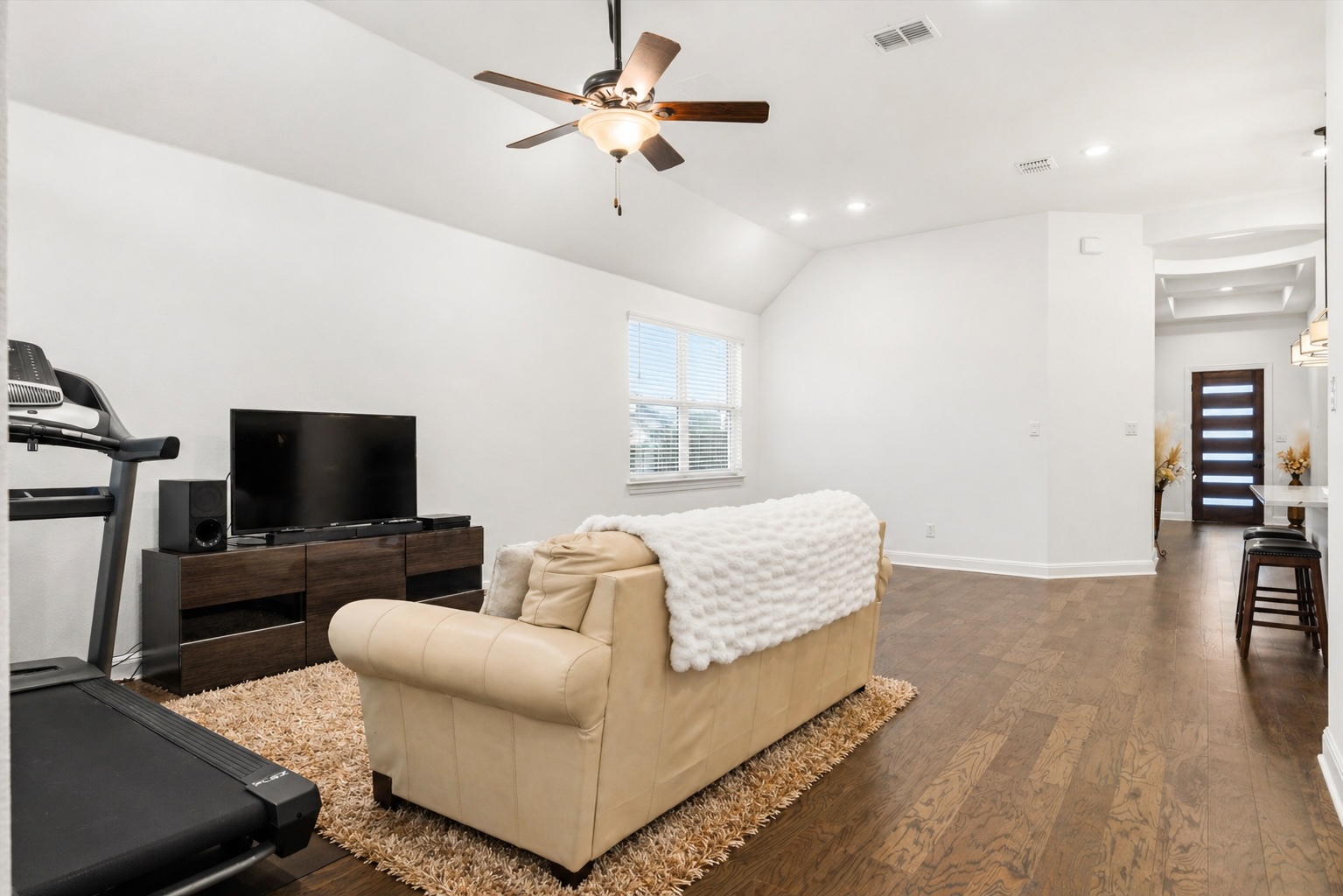 209 Rainier Drive Kyle, TX 78640 - Photo 21 of 24 Open-concept living space featuring wood-finish flooring, vaulted ceilings, and recessed lighting