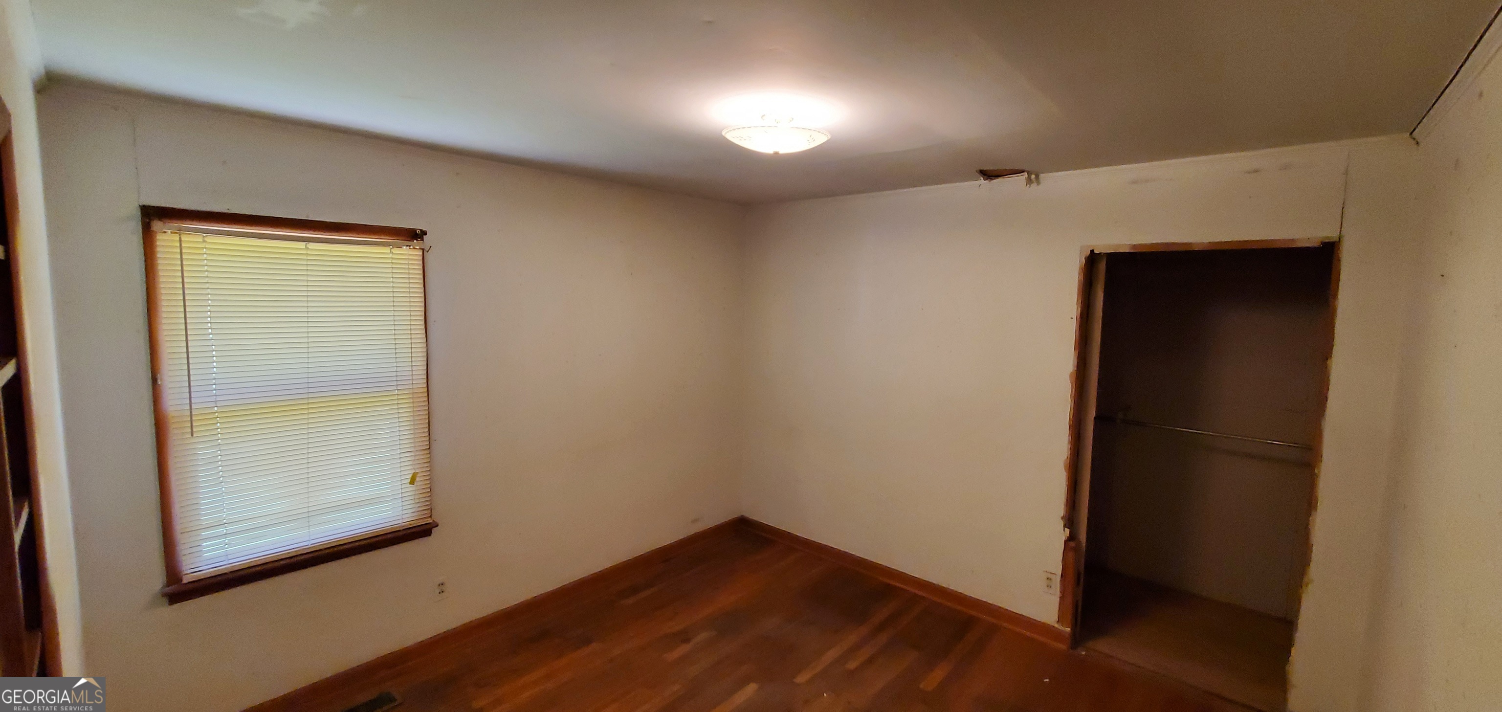 1061 Burger Road Watkinsville, GA 30677 - Photo 5 of 43 an empty room with wooden floor and windows