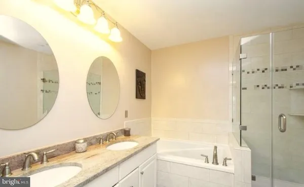 a bathroom with a granite countertop sink mirror and double