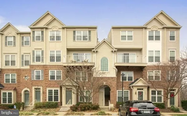 a front view of a residential apartment building with a yard