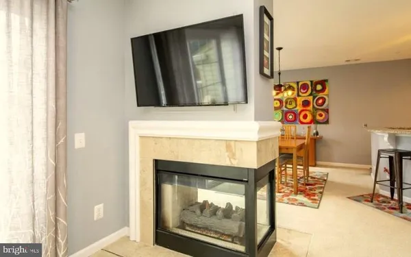 a view of living room with furniture and a fireplace