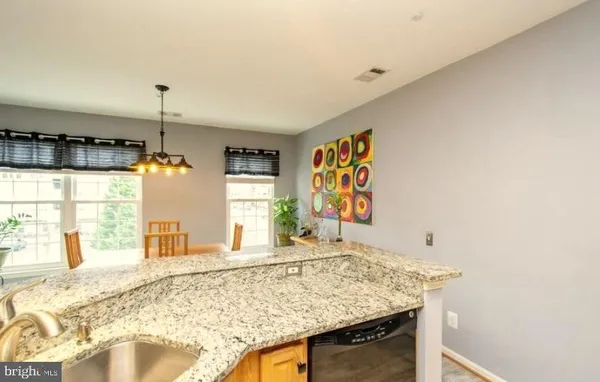 a view of a kitchen with kitchen island and windows