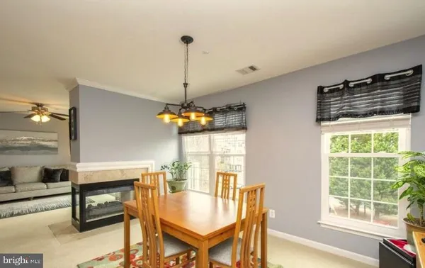 a dining room with furniture and window