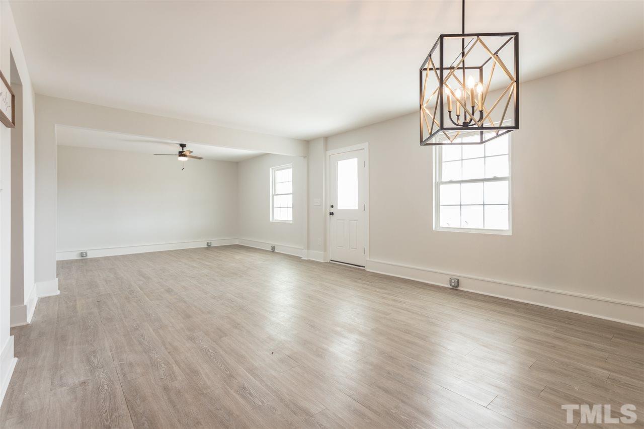 937 Wilson Road Clinton, NC 28328 - Photo 12 of 28 an empty room with wooden floor cabinet and windows