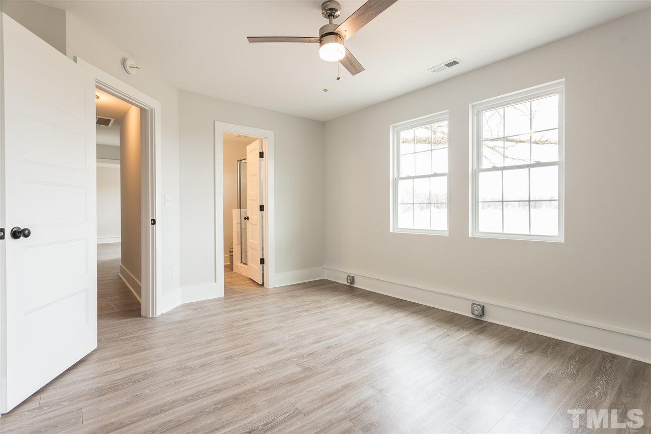 937 Wilson Road Clinton, NC 28328 - Photo 20 of 28 a view of an empty room with wooden floor and a window