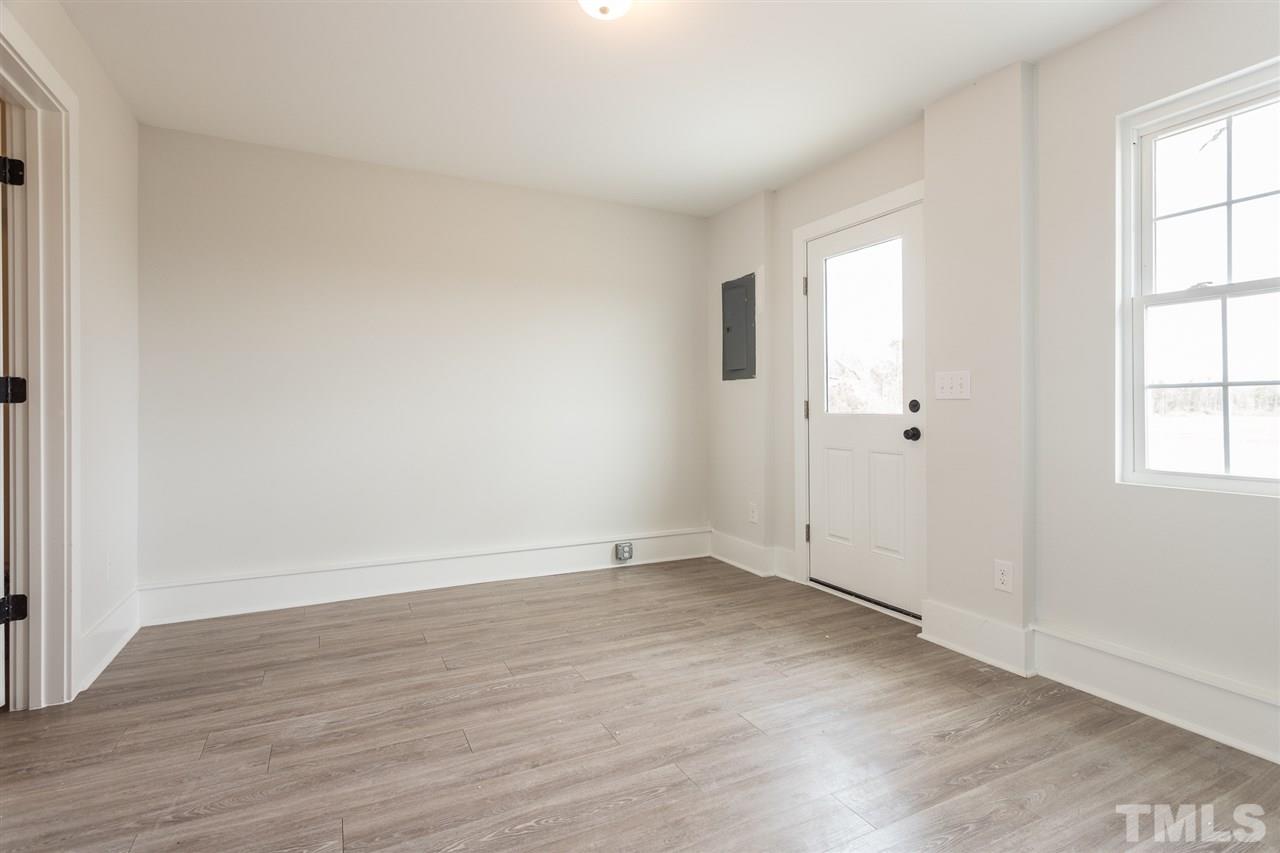 937 Wilson Road Clinton, NC 28328 - Photo 22 of 28 an empty room with wooden floor and windows