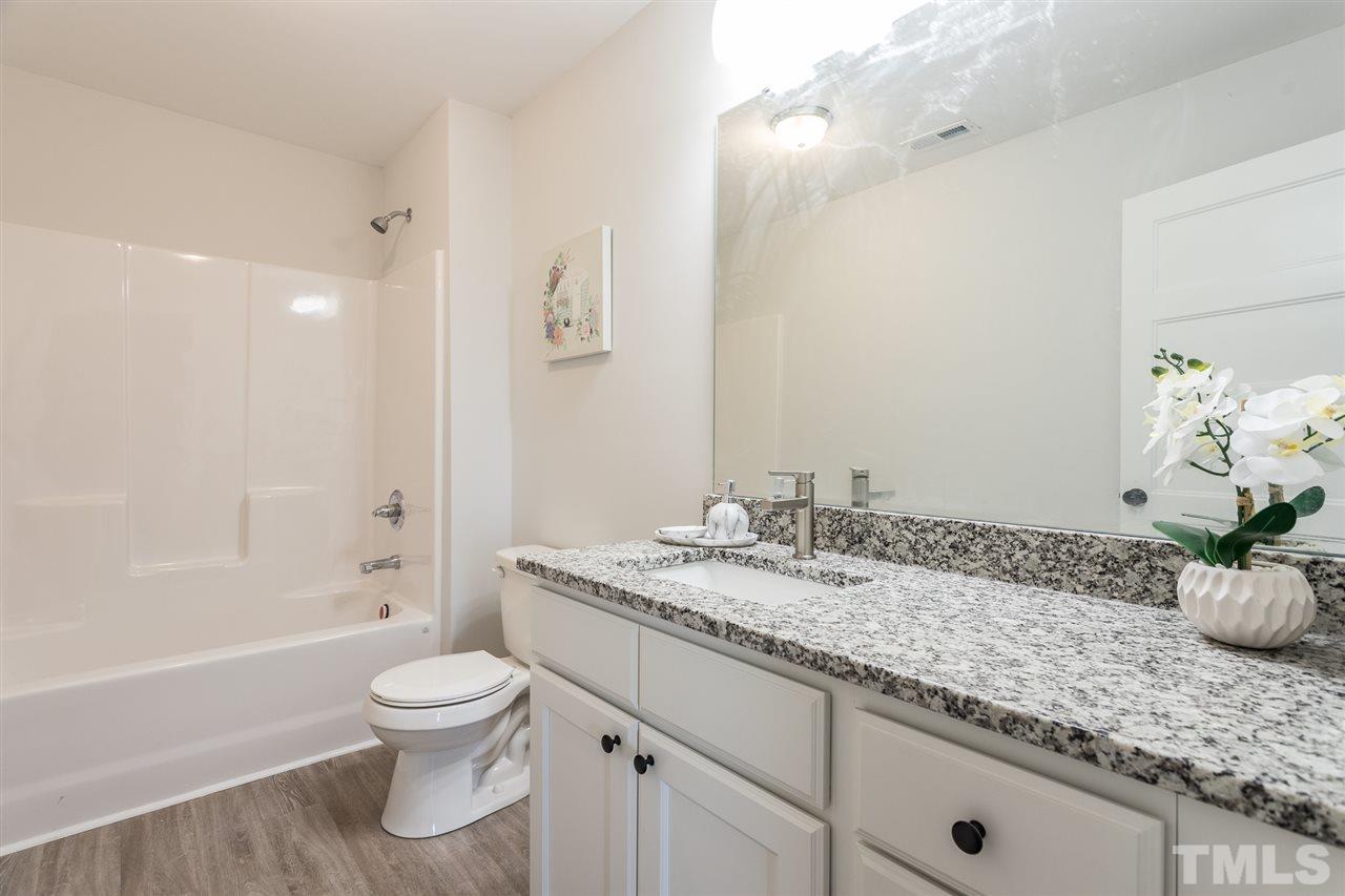 937 Wilson Road Clinton, NC 28328 - Photo 24 of 28 a bathroom with a granite countertop sink a toilet and shower