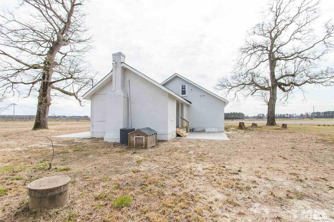 937 Wilson Road Clinton, NC 28328 - Photo 28 of 28 a backyard of a house with table and chairs