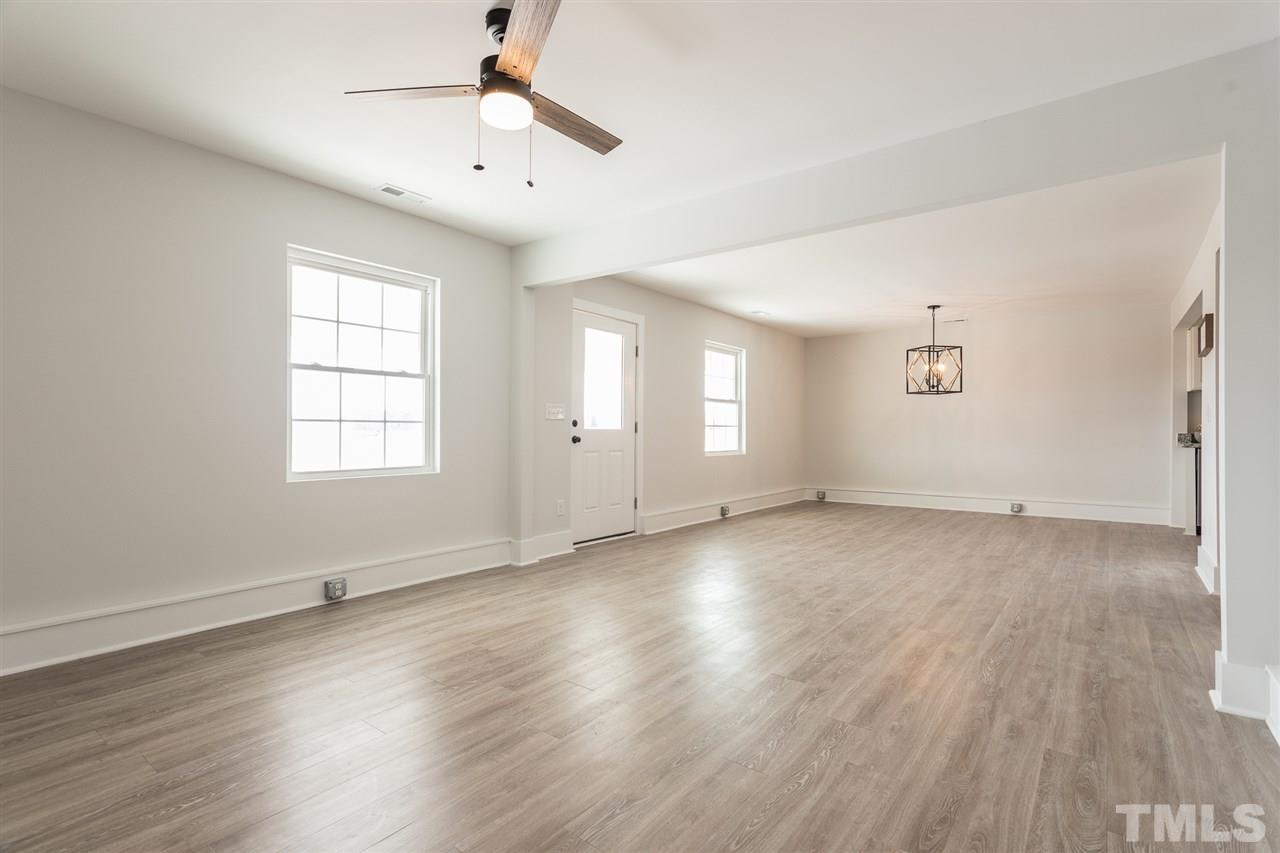 937 Wilson Road Clinton, NC 28328 - Photo 9 of 28 an empty room with wooden floor and windows