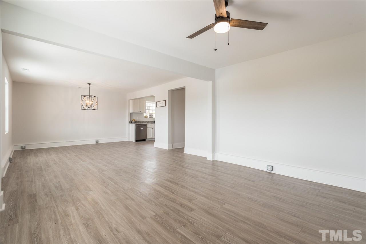 937 Wilson Road Clinton, NC 28328 - Photo 10 of 28 a view of empty room with wooden floor and ceiling fan