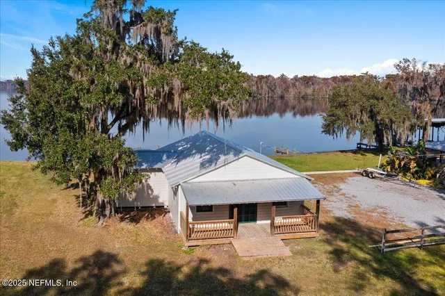 a view of a patio with table and chairs with wooden fence and plants