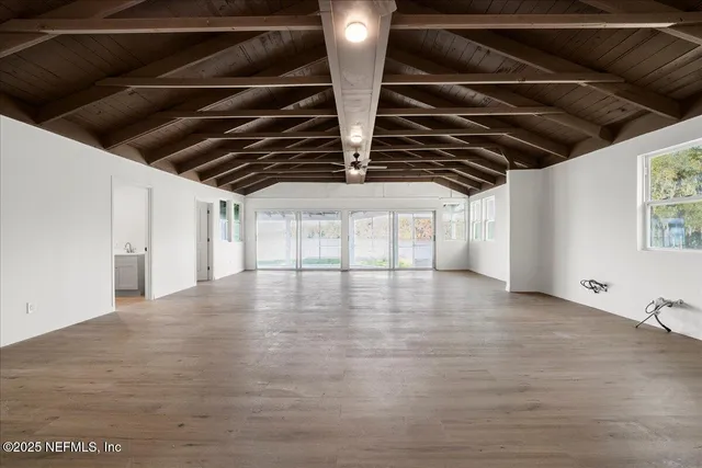 a view of a room with wooden floor