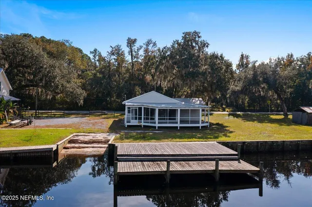 a view of a house with swimming pool and yard