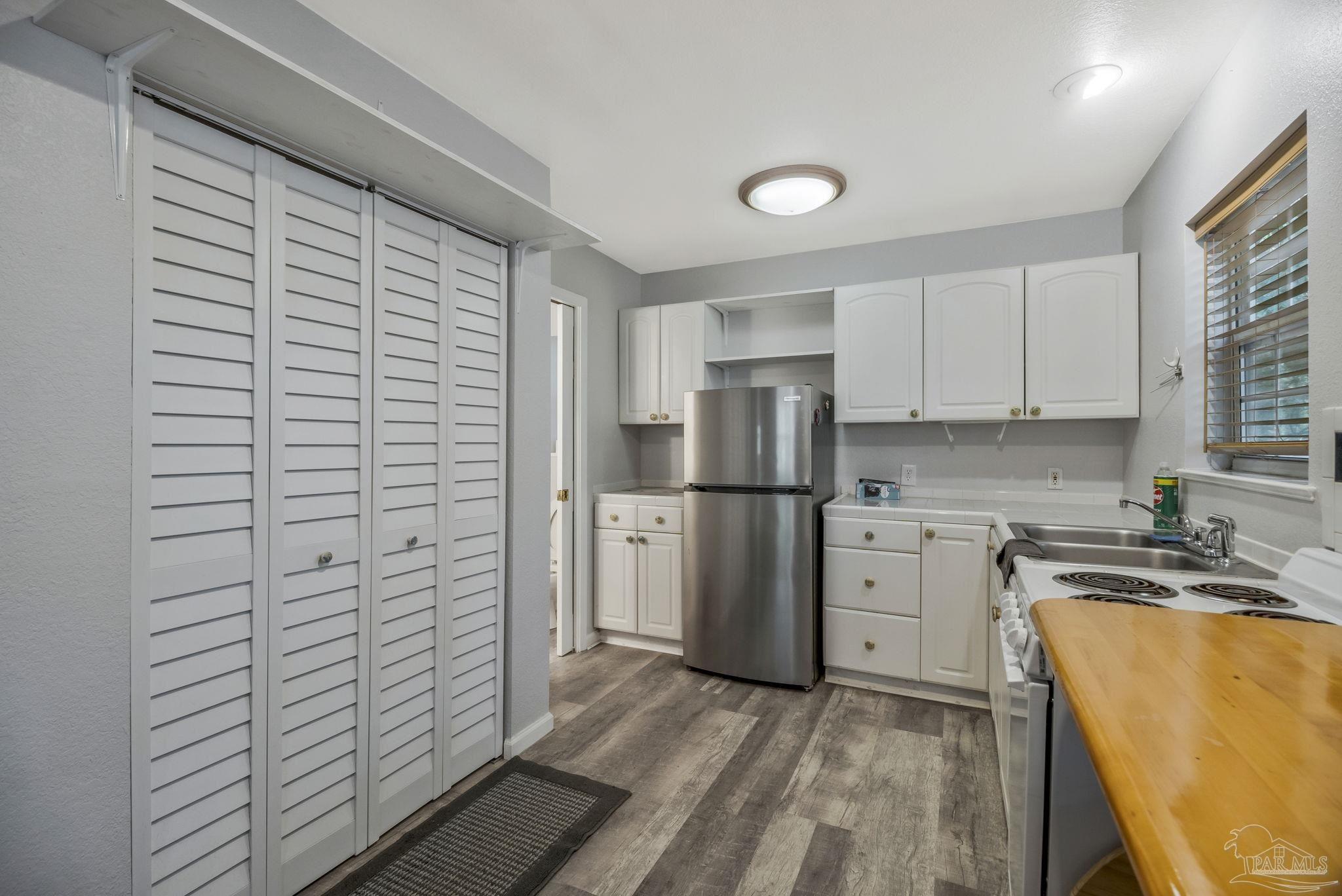 10290 West Lake Road Milton, FL 32583 - Photo 5 of 53 a kitchen with a refrigerator and a sink