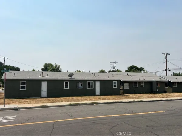 a front view of a house with a street