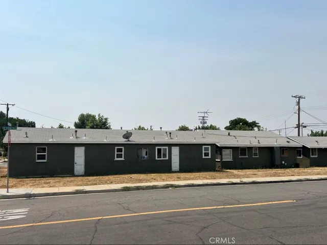 a front view of a house with a street