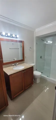 a bathroom with a sink a toilet and a large mirror