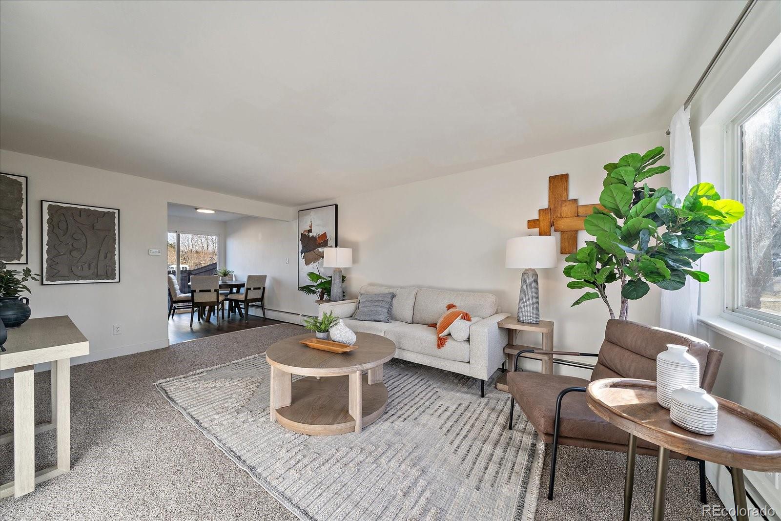 a living room with furniture and a potted plant