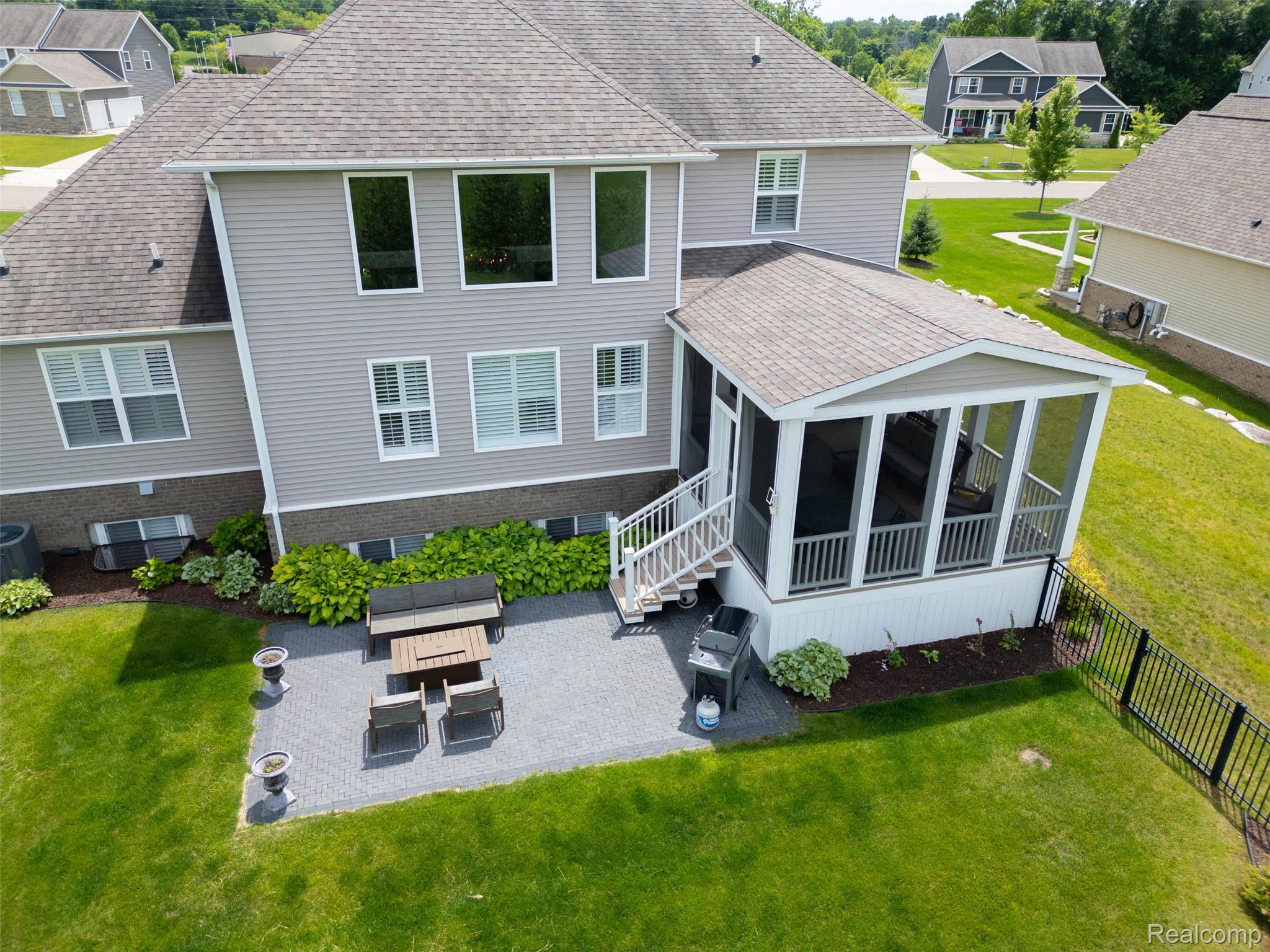 2531 Walnut View Drive Howell, MI 48855 - Photo 4 of 34 Screened porch with white railings and exterior stairs