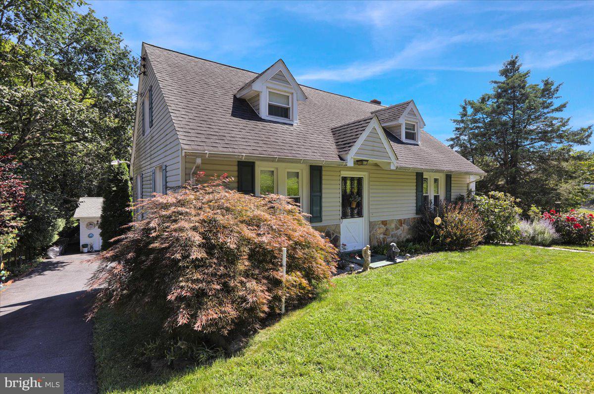 a front view of a house with yard and green space