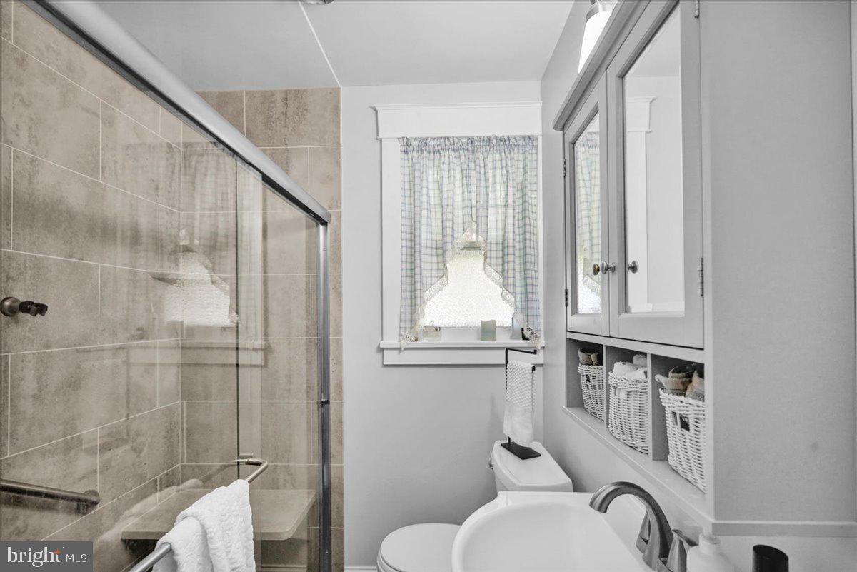 1717 Friedensburg Road Reading, PA 19606 - Photo 24 of 63 a bathroom with a toilet a sink and mirror