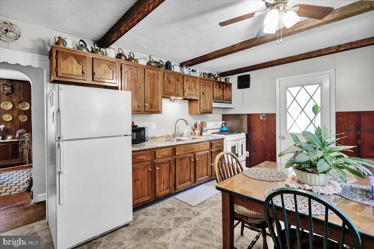 1717 Friedensburg Road Reading, PA 19606 - Photo 28 of 63 a kitchen with stainless steel appliances granite countertop a refrigerator a sink a stove and white cabinets