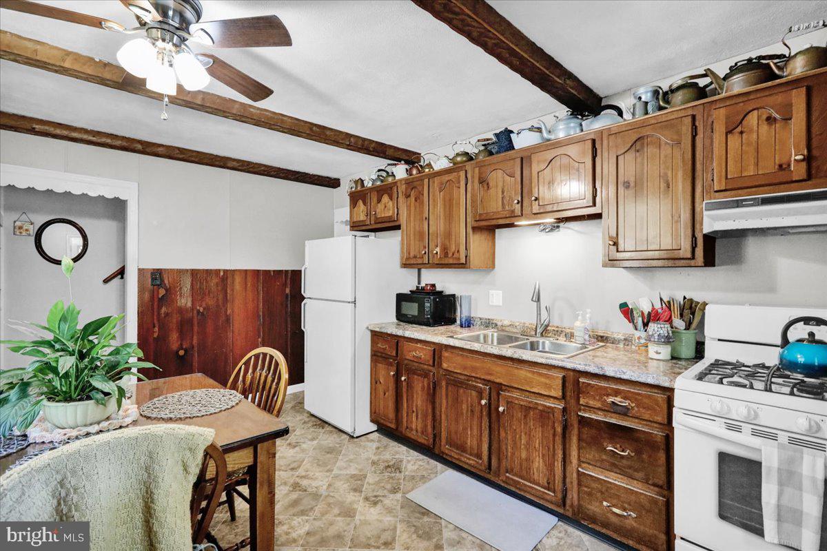 1717 Friedensburg Road Reading, PA 19606 - Photo 29 of 63 a kitchen with stainless steel appliances granite countertop a sink a stove and cabinets