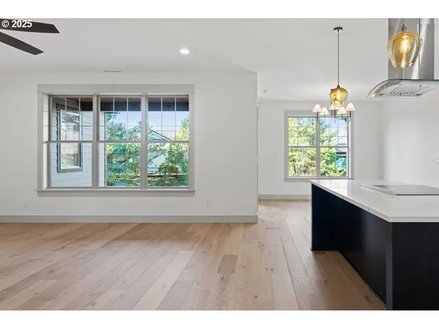 a hallway with a wooden floor and a window