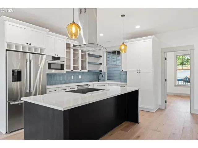 a kitchen with sink and refrigerator