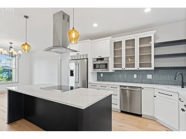 a kitchen with a sink cabinets and window