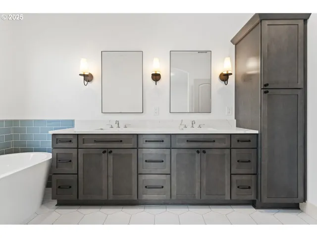 a bathroom with a tub sink and mirror