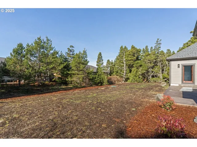 a view of a big house with a big yard and large tree