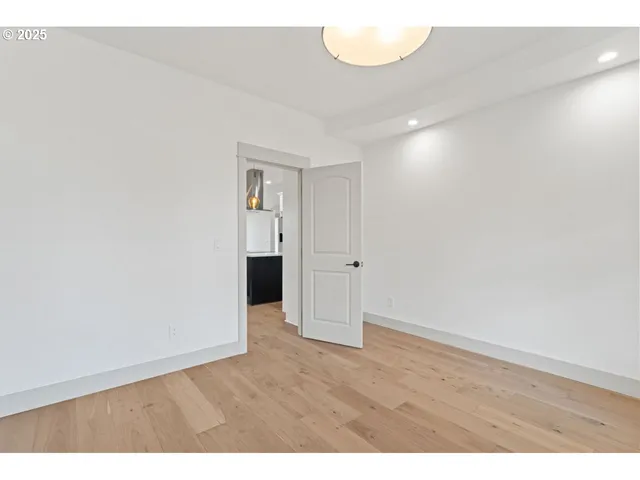 a view of an empty room and wooden floor