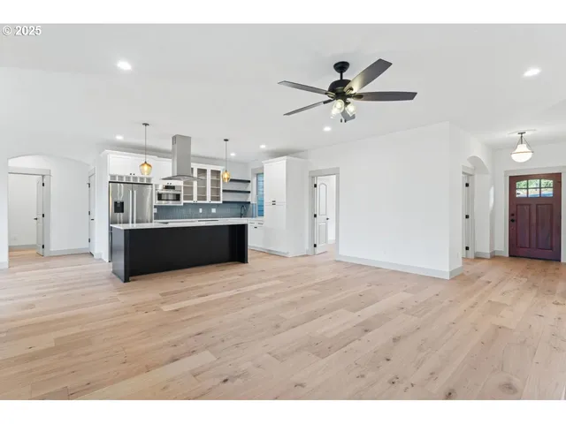 a view of a kitchen with a sink and a ceiling fan